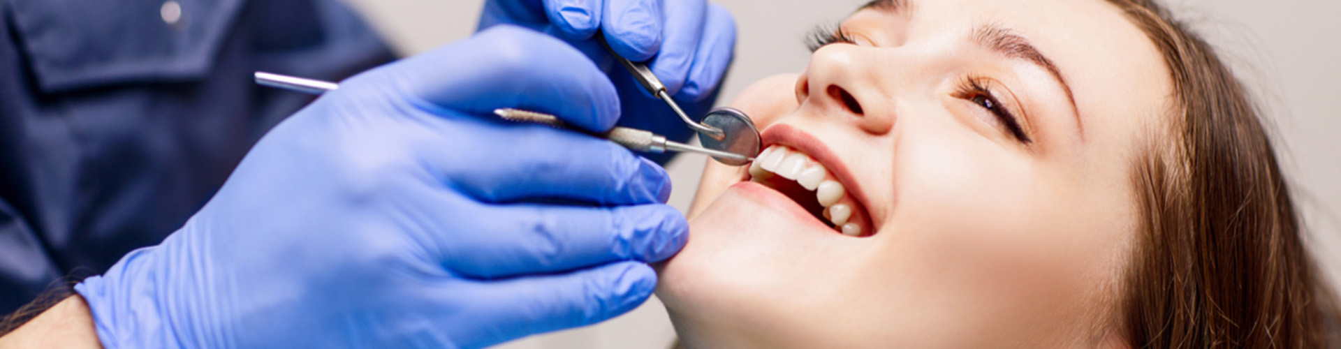 female having teeth checked at dentist.