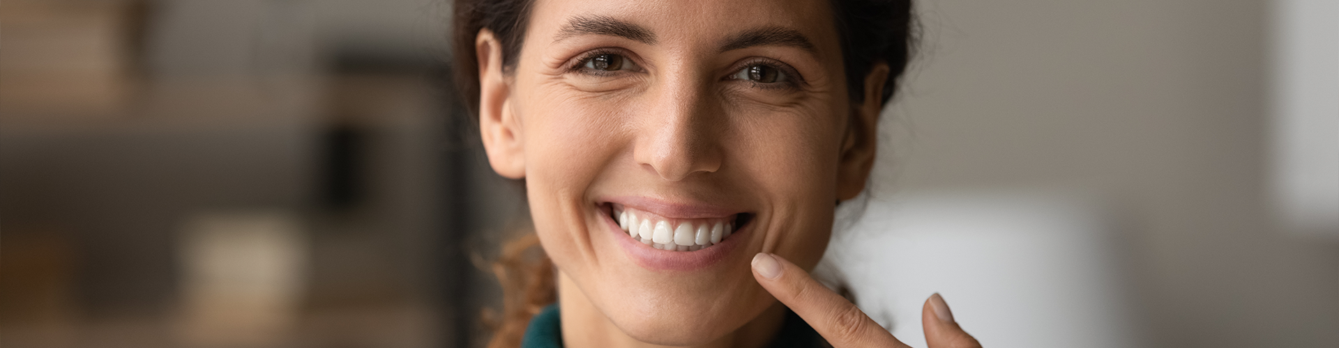 woman pointing at her smile.