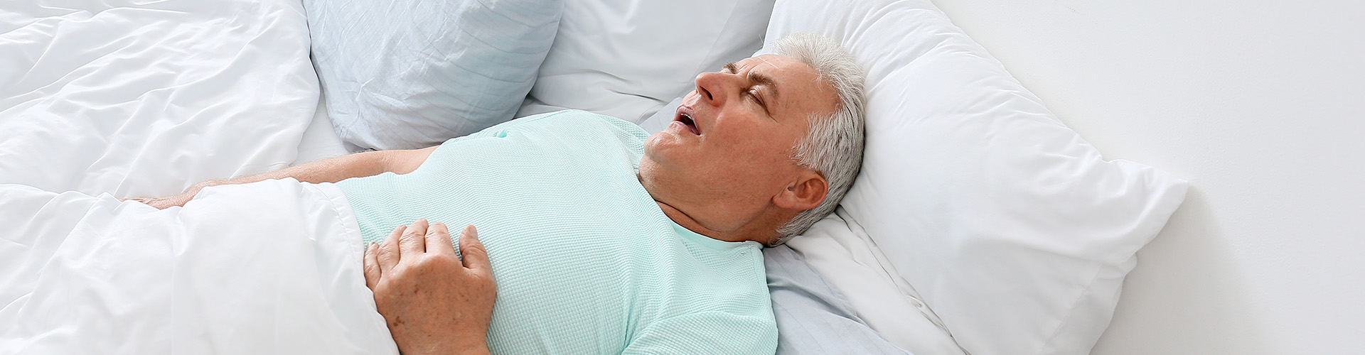 man sleeping on his back with his mouth open.