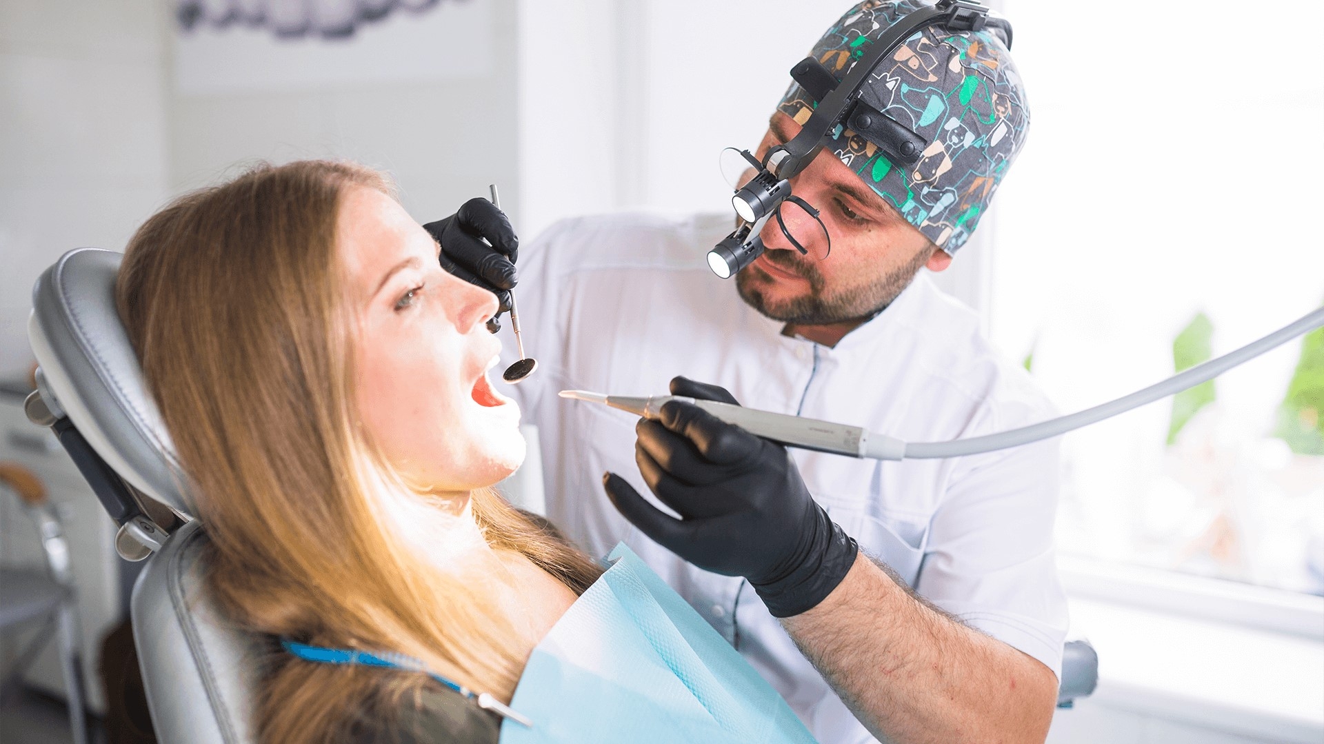 Dentist performing cavities dental treatment on patient.
