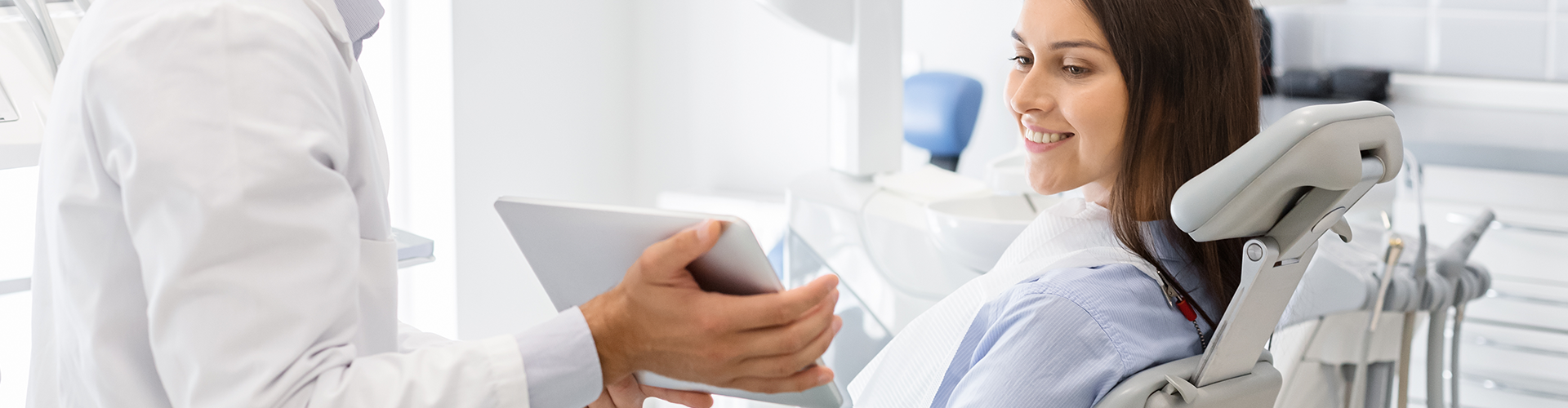 dentist showing a tablet to a patient.