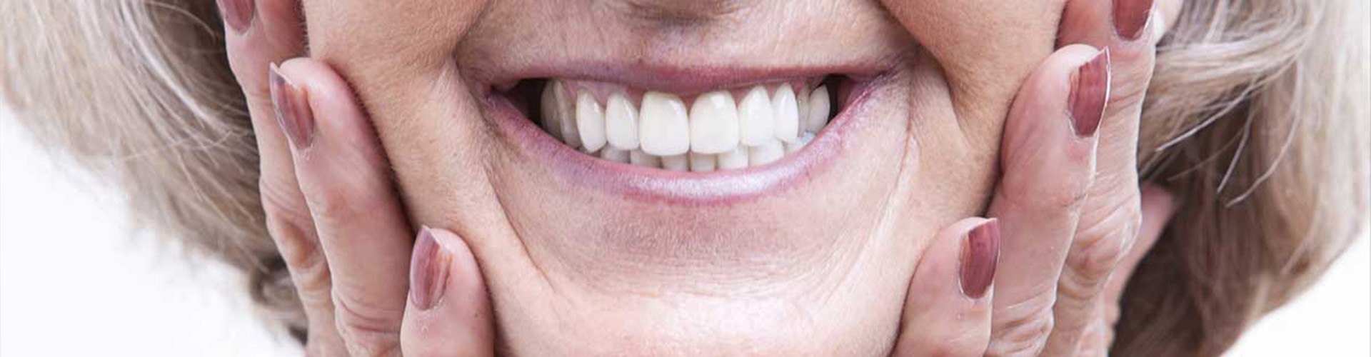 Woman holding her face and smiling.