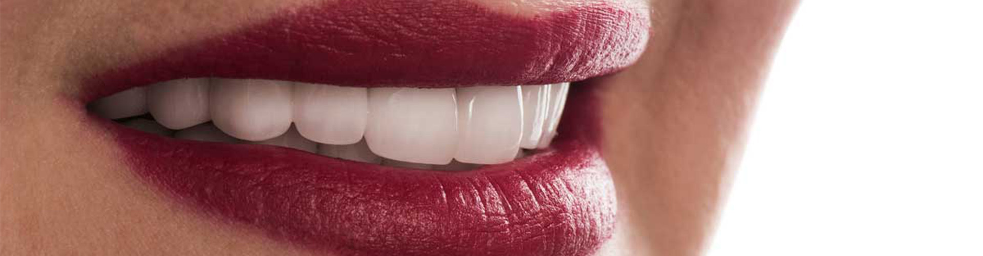 Woman with red lipstick smiling.