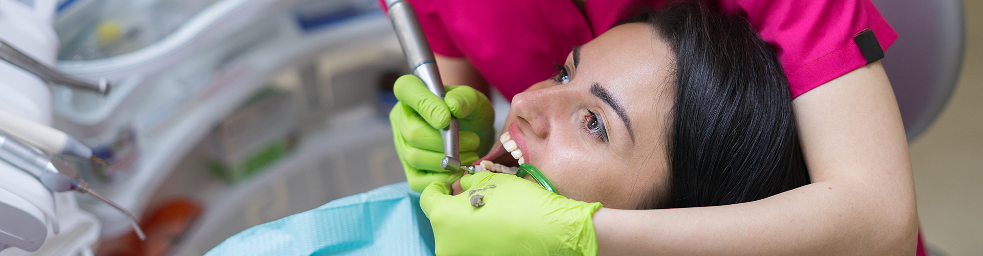 dentist working with dental tools in patient's mouth.